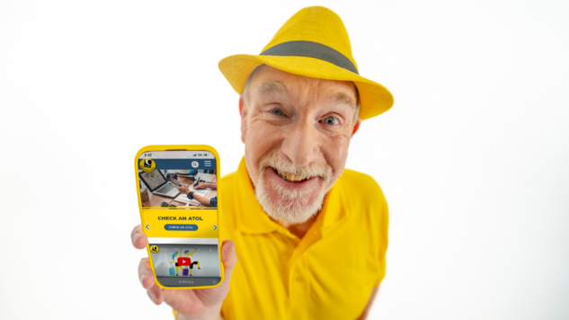 Man with a hat on holding a smartphone